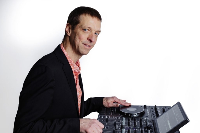 Chase March DJ Chase March looking to the side of his DJ controller